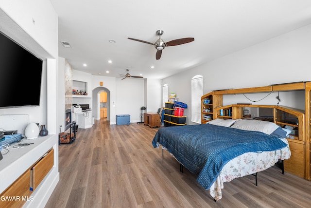 42094 W 21st St, Lancaster, CA 93536 - bedroom featuring arched walkways, light wood-style flooring, recessed lighting, and ceiling fan