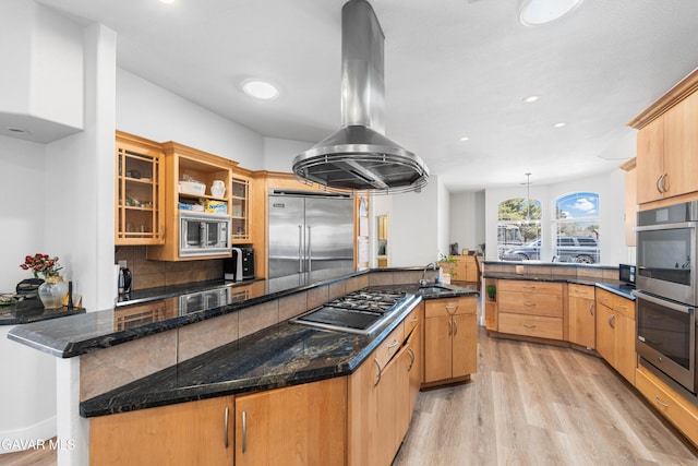 42094 W 21st St, Lancaster, CA 93536 - kitchen featuring built in appliances, a peninsula, light wood-style floors, island range hood, and backsplash