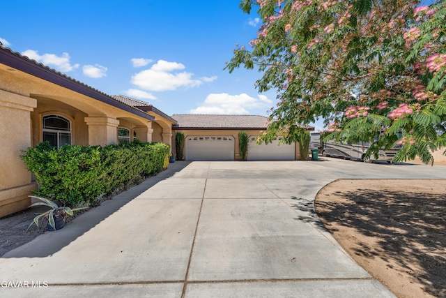 42094 W 21st St, Lancaster, CA 93536 - view of front of house featuring concrete driveway, stucco siding, a garage, and a tile roof