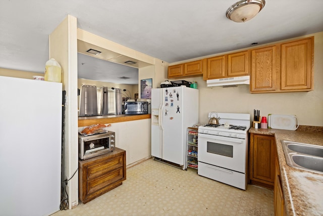 kitchen featuring white appliances and sink