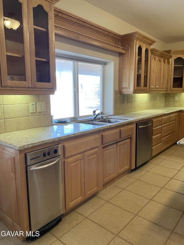 32941 Agua Dulce Canyon Rd, Agua Dulce, CA 91390 - kitchen featuring stainless steel dishwasher, light tile patterned floors, decorative backsplash, and glass insert cabinets