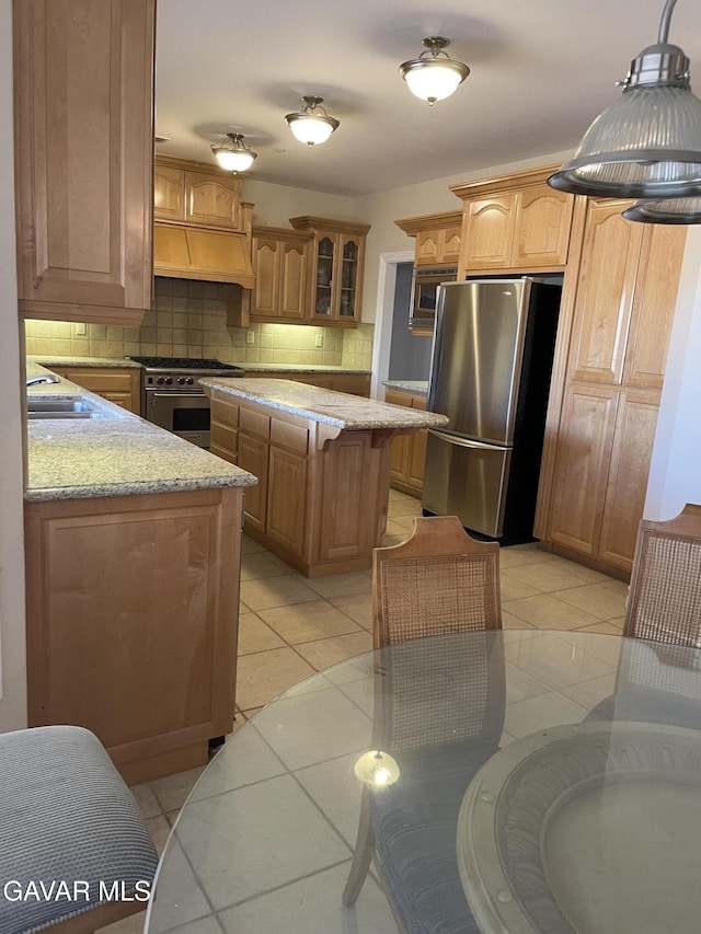 32941 Agua Dulce Canyon Rd, Agua Dulce, CA 91390 - kitchen featuring appliances with stainless steel finishes, backsplash, custom range hood, glass insert cabinets, and light stone counters