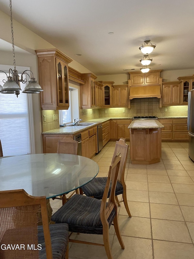 32941 Agua Dulce Canyon Rd, Agua Dulce, CA 91390 - kitchen featuring appliances with stainless steel finishes, custom range hood, light countertops, decorative backsplash, and glass insert cabinets
