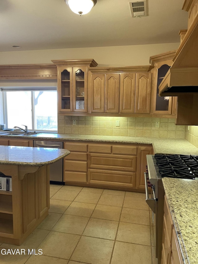 32941 Agua Dulce Canyon Rd, Agua Dulce, CA 91390 - kitchen with appliances with stainless steel finishes, tasteful backsplash, glass insert cabinets, and light stone countertops