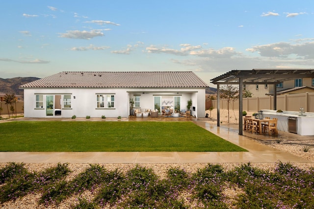 rear view of property with a patio area, a pergola, an outdoor bar, an outdoor kitchen, and ceiling fan