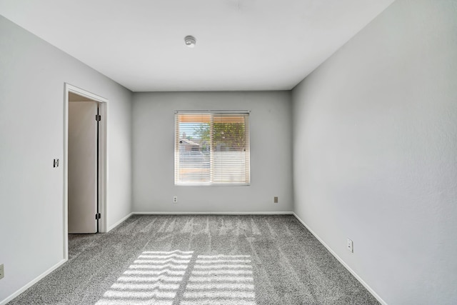 spare room featuring light carpet