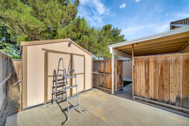 view of patio featuring a storage shed