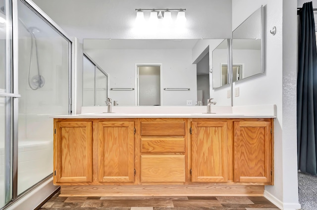 bathroom with vanity and a shower with shower door