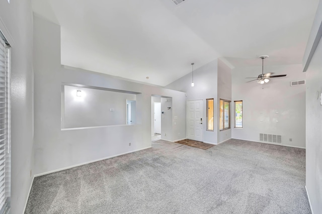 carpeted spare room with high vaulted ceiling and ceiling fan