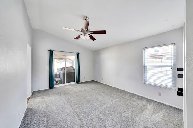 empty room featuring light carpet, vaulted ceiling, and ceiling fan