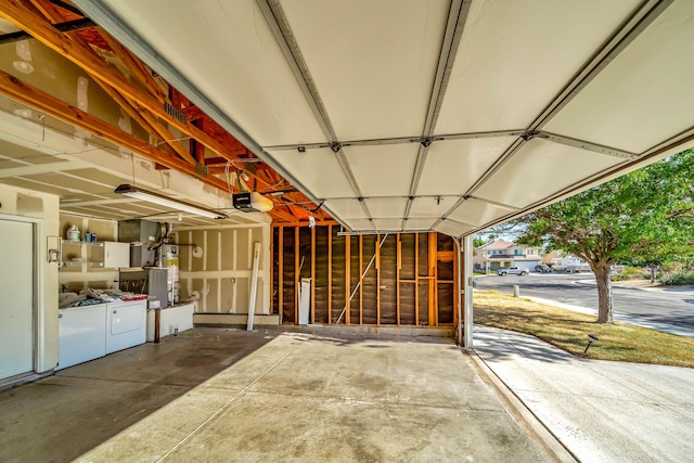 garage with strapped water heater and a garage door opener