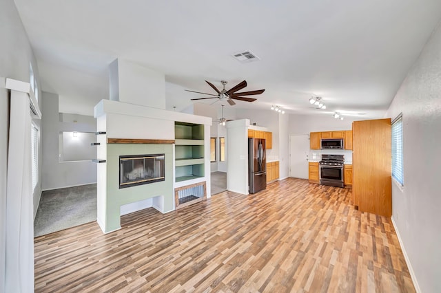 unfurnished living room with built in features, light hardwood / wood-style floors, high vaulted ceiling, and ceiling fan