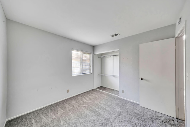 unfurnished bedroom with carpet and a closet