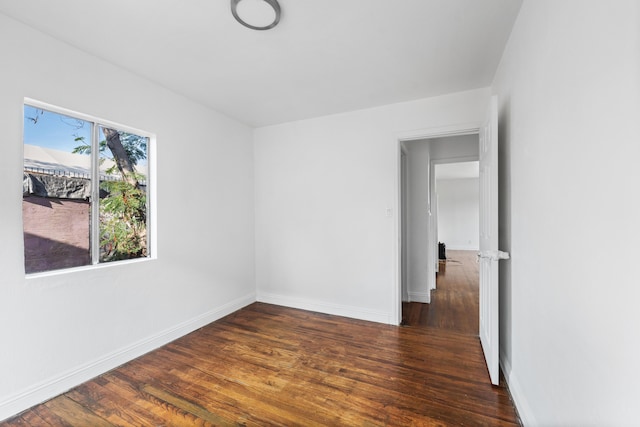 empty room with dark hardwood / wood-style floors