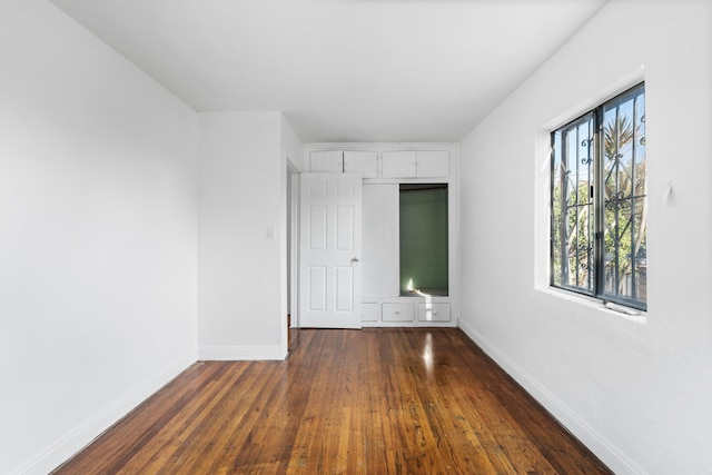 empty room with dark hardwood / wood-style floors