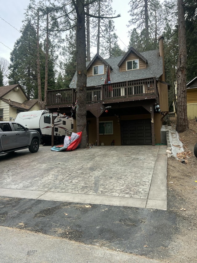 view of front of property with a wooden deck and a garage