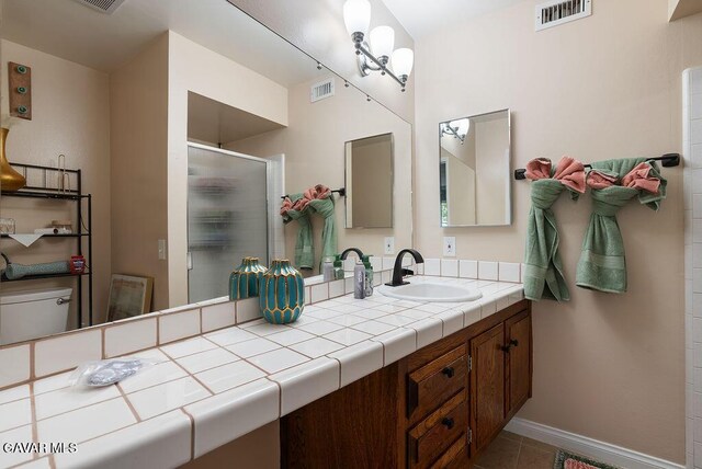 43818 Halcom Ave, Lancaster, CA 93536 - bathroom with a shower stall, vanity, and tile patterned floors