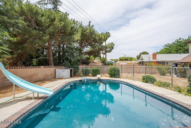 43818 Halcom Ave, Lancaster, CA 93536 - view of swimming pool with a water slide, a fenced backyard, and a diving board