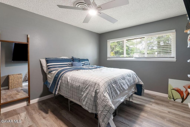 43818 Halcom Ave, Lancaster, CA 93536 - bedroom featuring a textured ceiling, wood finished floors, and a ceiling fan