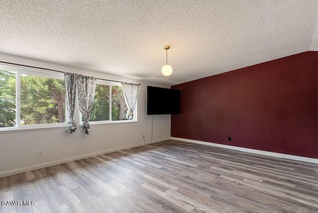 43818 Halcom Ave, Lancaster, CA 93536 - unfurnished room featuring a textured ceiling and wood finished floors