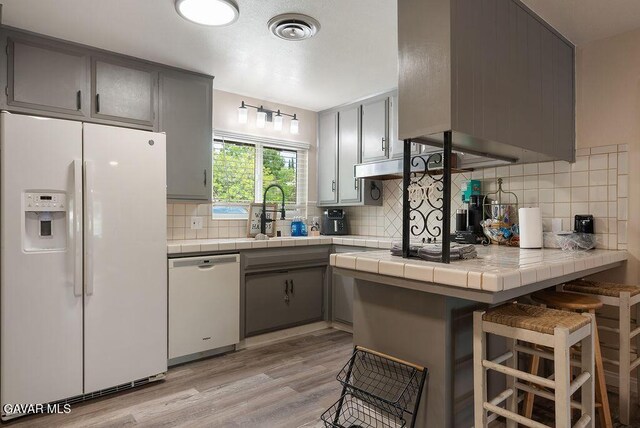 43818 Halcom Ave, Lancaster, CA 93536 - kitchen with white appliances, gray cabinets, and tile counters