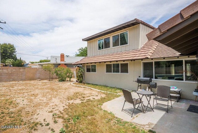 43818 Halcom Ave, Lancaster, CA 93536 - rear view of property featuring a patio area and board and batten siding