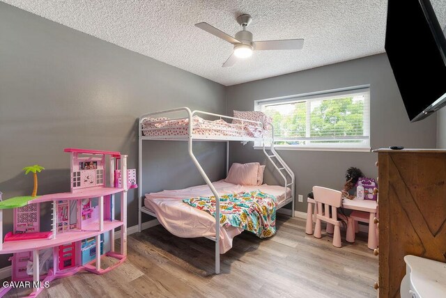 43818 Halcom Ave, Lancaster, CA 93536 - bedroom with wood finished floors, a textured ceiling, and a ceiling fan