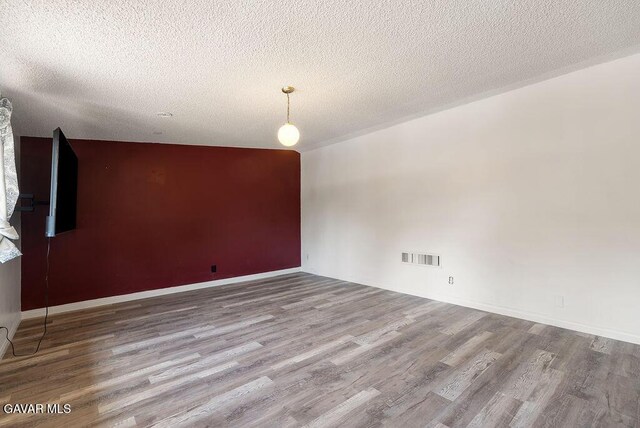 43818 Halcom Ave, Lancaster, CA 93536 - unfurnished room with wood finished floors and a textured ceiling
