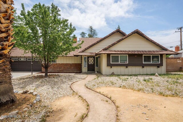 43818 Halcom Ave, Lancaster, CA 93536 - view of front of home with a garage, driveway, and board and batten siding