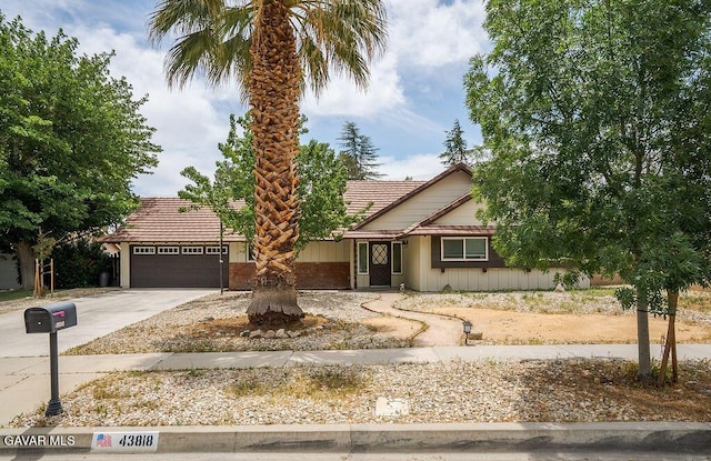 43818 Halcom Ave, Lancaster, CA 93536 - view of front of house featuring a garage, concrete driveway, and a tiled roof