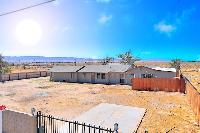 back of house with a mountain view