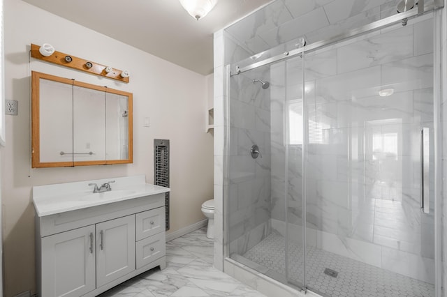 bathroom featuring vanity, toilet, and walk in shower