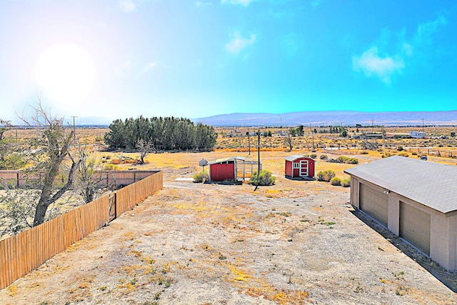 exterior space with a mountain view, a rural view, and an outbuilding