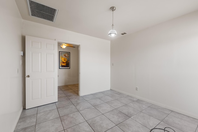 unfurnished room with ceiling fan and light tile patterned flooring