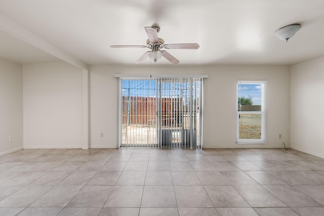 tiled spare room featuring ceiling fan