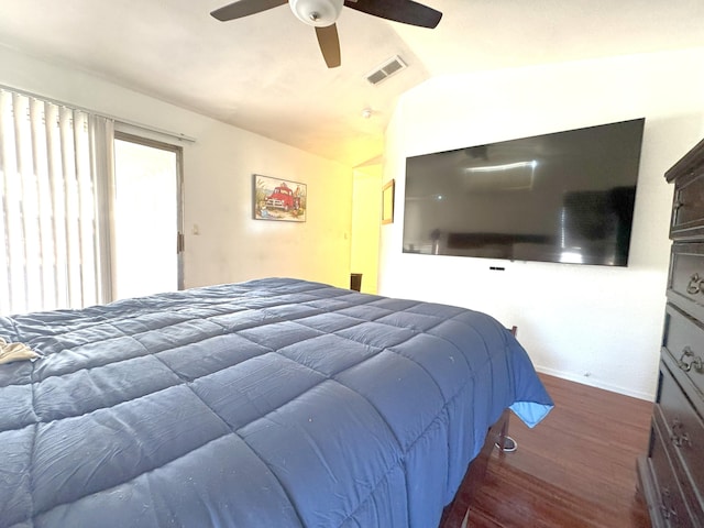 bedroom featuring dark hardwood / wood-style flooring, ceiling fan, and lofted ceiling