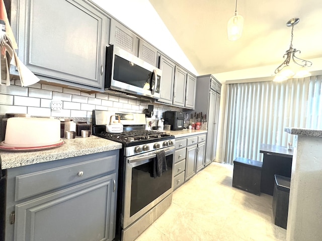 kitchen featuring backsplash, gray cabinetry, stainless steel appliances, vaulted ceiling, and pendant lighting