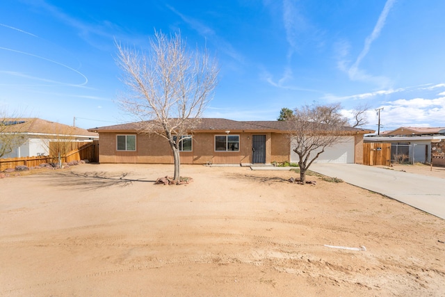 20360 86th St, California City, CA 93505 - ranch-style home featuring concrete driveway, fence, stucco siding, and an attached garage