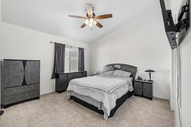 carpeted bedroom with vaulted ceiling, baseboards, and ceiling fan