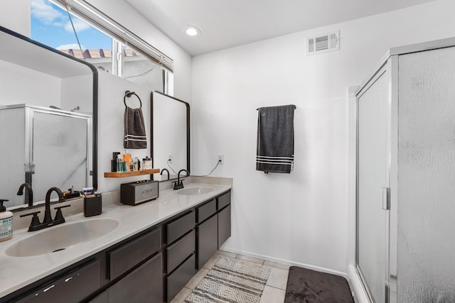 full bathroom with a sink, visible vents, a stall shower, and tile patterned flooring