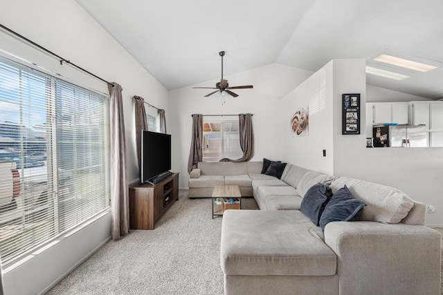 living room with light colored carpet, ceiling fan, and vaulted ceiling