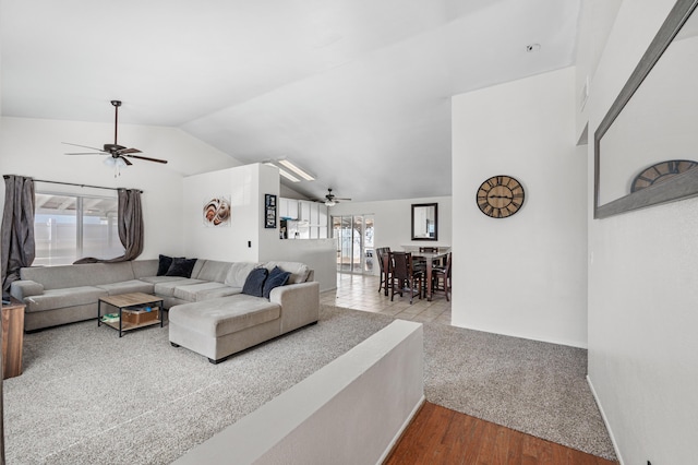 living room with wood finished floors, lofted ceiling, and ceiling fan