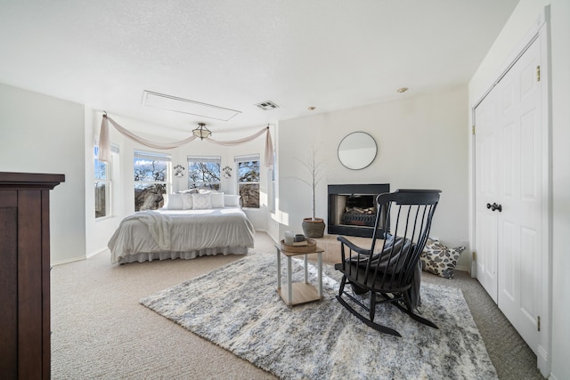 bedroom featuring a textured ceiling and carpet