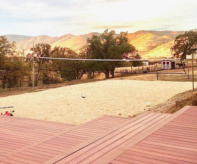 surrounding community featuring a mountain view and volleyball court