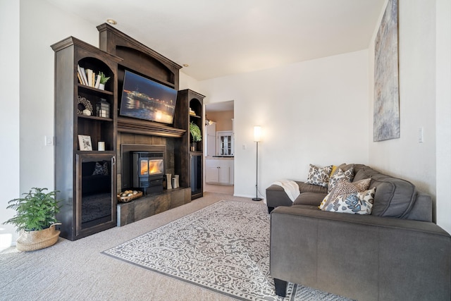 carpeted living room with a fireplace