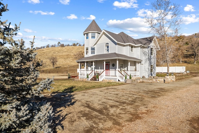 victorian home with a porch and a front lawn