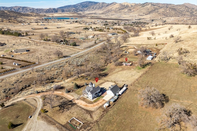 drone / aerial view featuring a mountain view and a rural view