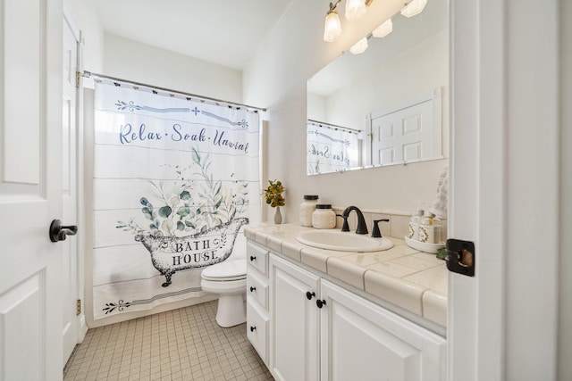 bathroom with vanity, tile patterned floors, and toilet