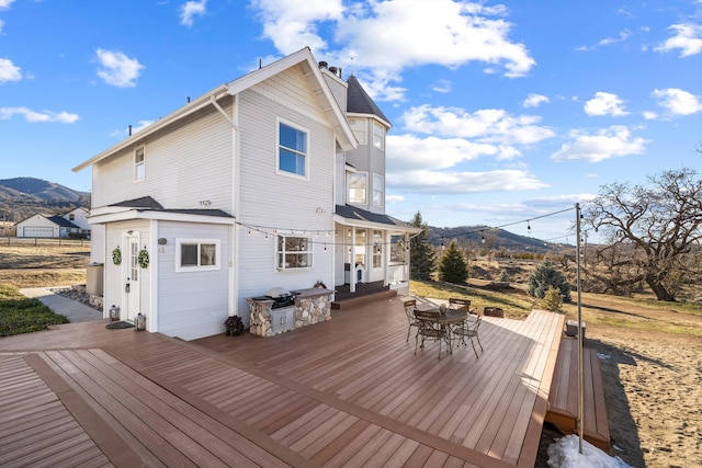 back of house with a deck with mountain view