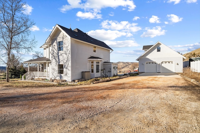 view of property exterior featuring a porch and a garage